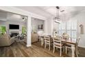 Open-concept dining room featuring modern light fixture and views of the living room at 1024 Brownstone Dr # 2, Marietta, GA 30008
