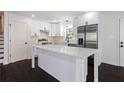 Modern kitchen with white cabinetry, stainless steel appliances, and quartz countertops at 504 Milligan Dr, Stone Mountain, GA 30083