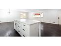 Kitchen with white island, cabinets, black hardware, and stainless steel appliances at 504 Milligan Dr, Stone Mountain, GA 30083