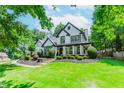 Beautifully landscaped front yard featuring lush green grass and manicured bushes, enhancing curb appeal at 2373 Oak Falls Ln, Buford, GA 30519