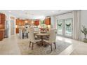Bright dining area featuring a cozy round table and kitchen with stainless appliances at 625 St Annes Pl, Covington, GA 30016