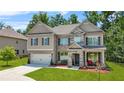 Inviting two-story home boasting a blend of brick, stone, and siding with a manicured front yard at 625 St Annes Pl, Covington, GA 30016