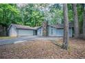 Beautiful single-story home with an attached garage, complemented by a stone chimney and lush landscaping at 4116 Wendell Way, Snellville, GA 30039