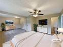 Spacious primary bedroom with ample closet space, en-suite bathroom, and modern ceiling fan, virtually staged at 8272 Magnolia Dr, Jonesboro, GA 30238