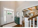 Light and airy foyer with hardwood floors, decorative cabinet, and views into adjacent rooms at 2535 Castlerock Ct, Cumming, GA 30041