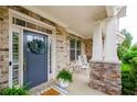 Inviting covered front porch featuring rocking chairs and a wreath-adorned front door at 2535 Castlerock Ct, Cumming, GA 30041