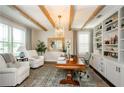 Bright home office featuring exposed beams, custom shelving, and a large desk at 2535 Castlerock Ct, Cumming, GA 30041