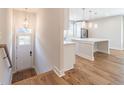 Welcoming entryway with stairs, hardwood floors, and an open view of the kitchen with a large island at 370 Thrasher St # 5, Norcross, GA 30071