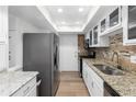 Well-lit kitchen showcasing granite countertops, stainless steel appliances, and mosaic backsplash for a modern touch at 6851 Roswell Rd # L1, Atlanta, GA 30328