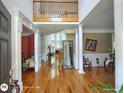 Grand foyer with hardwood floors, soaring ceilings, elegant columns, and a glimpse of the living spaces at 1292 Hidden Spirit Trl, Lawrenceville, GA 30045