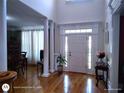 Inviting foyer with hardwood floors, a stylish front door, and classic architectural details at 1292 Hidden Spirit Trl, Lawrenceville, GA 30045