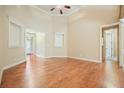 Spacious living room featuring hardwood floors, neutral walls, a ceiling fan, and multiple entryways at 620 Willow Haven Way, Suwanee, GA 30024