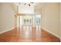 Spacious living room with high ceilings, hardwood floors, and ample natural light streaming in through windows at 620 Willow Haven Way, Suwanee, GA 30024