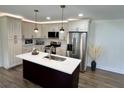 Bright kitchen with an island, stainless steel appliances, and modern finishes at 6751 Davidson Ct, Lithonia, GA 30058