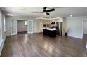 Open-concept living room and kitchen featuring hardwood floors at 6751 Davidson Ct, Lithonia, GA 30058
