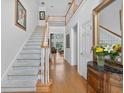Bright foyer with hardwood floors, staircase, and high ceilings leading to the home's living spaces at 2002 Ivy Ridge Se Rd, Smyrna, GA 30080