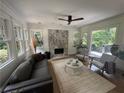 Bright living room with decorative fireplace, large windows, hardwood floors, and stylish furniture at 2088 Emery Ne Pl, Atlanta, GA 30317