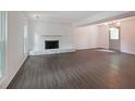 Spacious living room with a decorative fireplace and wood-look floors at 7156 Whitfield Drive Dr, Riverdale, GA 30296