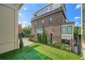 Private outdoor balcony offers a serene view with artificial turf and stylish black railing at 504 E Howard Ave, Decatur, GA 30030
