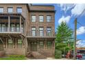 Gorgeous brick townhouse with a covered porch, balcony, and manicured landscaping at 504 E Howard Ave, Decatur, GA 30030