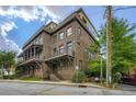 Stunning multi-story brick townhomes with inviting balconies and lush green landscaping at 504 E Howard Ave, Decatur, GA 30030