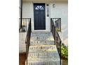 Inviting front entrance with updated iron railing and brick steps at 5347 Ocarol Ct, Stone Mountain, GA 30088