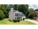 Charming two-story home featuring a well-manicured lawn and a two-car garage at 2161 Denson Sw Ln, Marietta, GA 30008