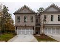 Beautiful three-story townhome with a tandem two-car garage and brick facade at 510 Winston Croft Cir # 56, Johns Creek, GA 30022