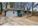 Side view of blue brick home with a wheelchair ramp and concrete driveway at 1089 Indale Sw Pl, Atlanta, GA 30310