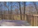 View from the wooden deck showing the property's private, tree-lined backyard at 169 Holly Ct, Loganville, GA 30052