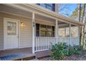 Inviting covered front porch with white railings, a cozy entrance, and charming curb appeal at 169 Holly Ct, Loganville, GA 30052