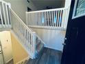 Entryway with stairs and white railing and plank flooring, leading to the upper level at 4007 Stacy Ln, Snellville, GA 30039