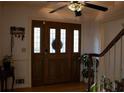 Inviting entrance with a wood door with glass panels and a decorative ceiling fan at 4640 Calleigh Way, Snellville, GA 30039