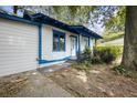 A white, wood-sided home with blue trim accents, complemented by a small porch with supporting columns at 1321 Mcclelland Ave, Atlanta, GA 30344