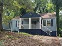 Charming blue home with a covered front porch surrounded by mature trees at 1417 Graymont Sw Dr, Atlanta, GA 30310