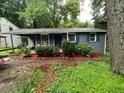 Quaint single-story home with grey brick, blue shutters, and well-landscaped front yard at 3530 Fairlane Nw Dr, Atlanta, GA 30331