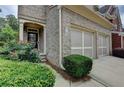 Charming brick home featuring a well-manicured lawn, an inviting entrance, and a two-car garage at 4165 Hammond Bridge Dr, Suwanee, GA 30024