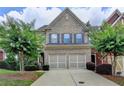 Charming two-story brick home with a two-car garage and a beautifully landscaped front yard at 4165 Hammond Bridge Dr, Suwanee, GA 30024