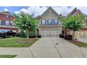 Beautifully landscaped two-story brick home with a two-car garage and inviting curb appeal at 4165 Hammond Bridge Dr, Suwanee, GA 30024