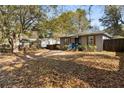 A single-story house with mature trees and a partial view of the fenced backyard at 501 Aberdeen Nw Dr, Atlanta, GA 30318