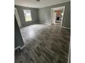 Open-concept living room boasts wood-look flooring, natural light, and modern neutral colors at 4402 Highland Rd, Decatur, GA 30035