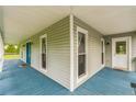 Spacious covered porch featuring painted wood flooring and multiple entry doors at 500 Coleman Mill Rd, Carrollton, GA 30116