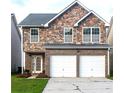 Charming two-story home with a stone facade and a two-car garage, set on a well-maintained lawn at 8838 Seneca Rd, Palmetto, GA 30268