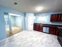 Bright kitchen with marble tile, stainless steel appliances, and cherry wood cabinets at 8838 Seneca Rd, Palmetto, GA 30268