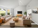 Bright, staged living room with vaulted ceilings, a neutral palette and large picture windows at 2226 Exchange Se Pl, Conyers, GA 30013