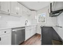 This modern kitchen features all white cabinets, backsplash, countertops and new appliances at 1 Lamar Ave Sw, Atlanta, GA 30310