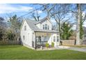 Quaint two-story house with a front porch, neatly kept lawn and tidy walkway leading to the front door at 1995 Meador Ave, Atlanta, GA 30315