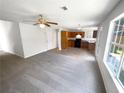 Bright living room with large windows, an open layout, neutral carpet and view of the kitchen at 509 Carlton Pointe Dr, Palmetto, GA 30268