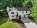 An aerial view of the beautiful two-story home with a two-car garage, surrounded by a well-manicured lawn at 975 Memory Ln, Lawrenceville, GA 30044