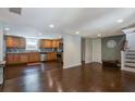 Open kitchen with stainless steel appliances, wood cabinets and hardwood floors at 174 Rivertown Rd, Fairburn, GA 30213